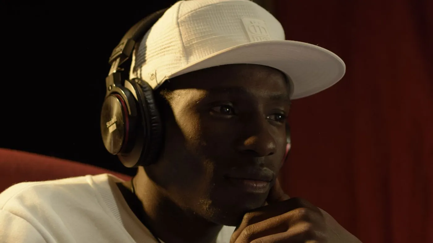Producer wearing headphones focused on building an audience in the studio