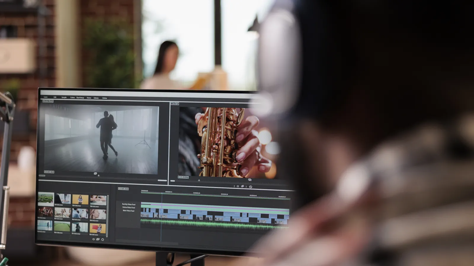 Young freelancer editing footage with color grading and audio effects on a computer