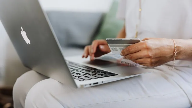Buying a digital product online with a card on a laptop
