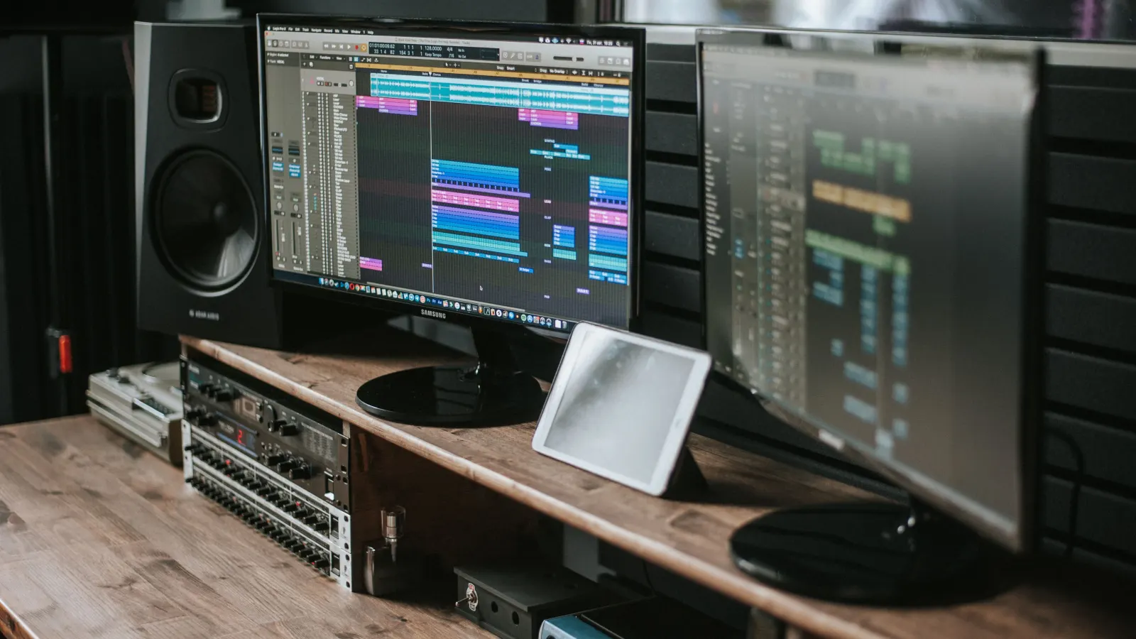 Musician recording in a studio with headphones and mixer