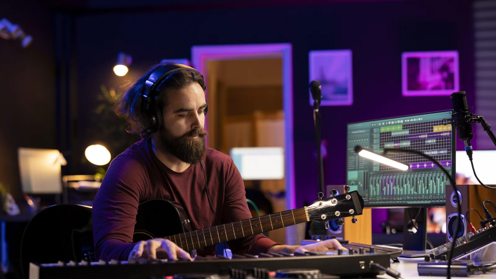 Sound engineer in a studio wearing headphones at the desk