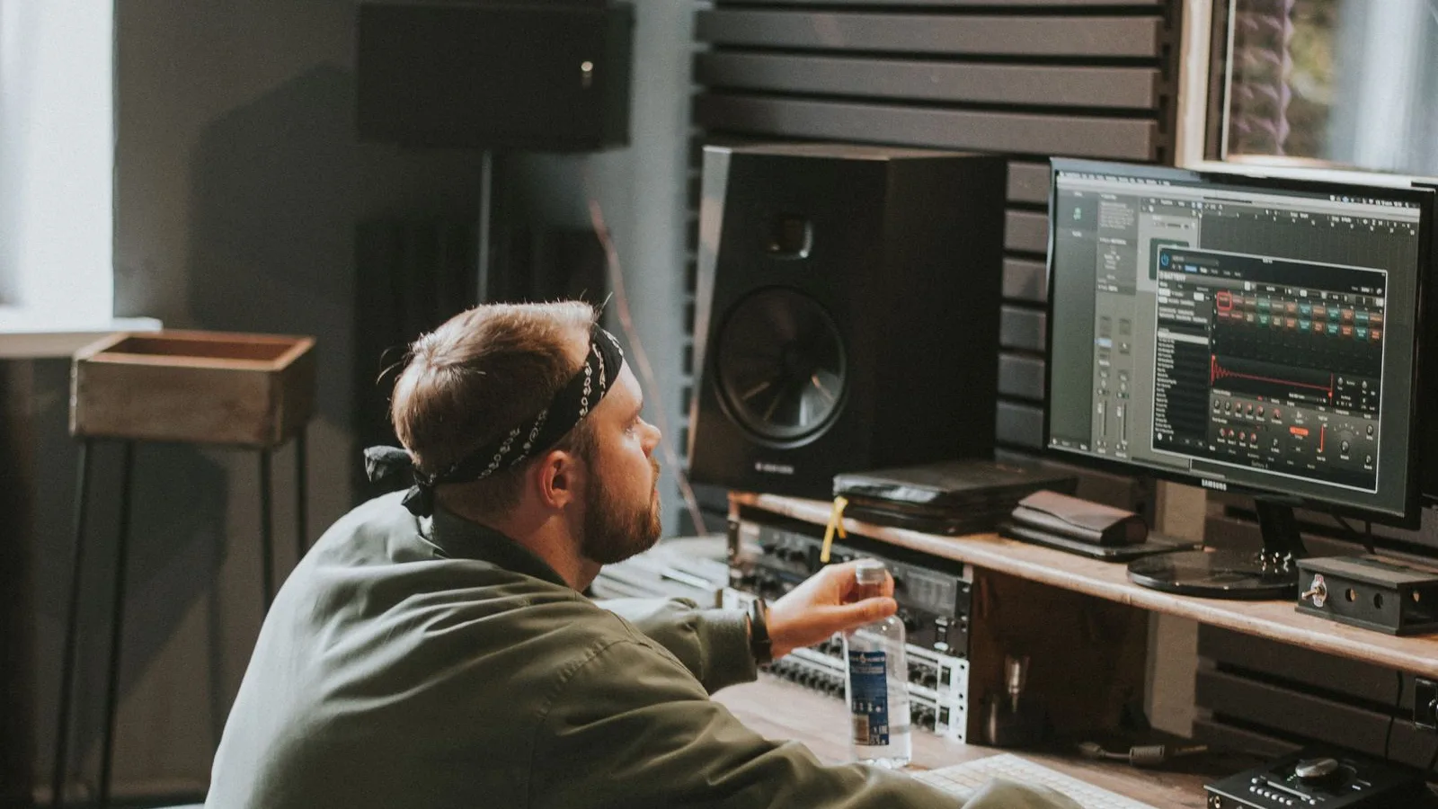 Music producer working at a DAW in a recording studio