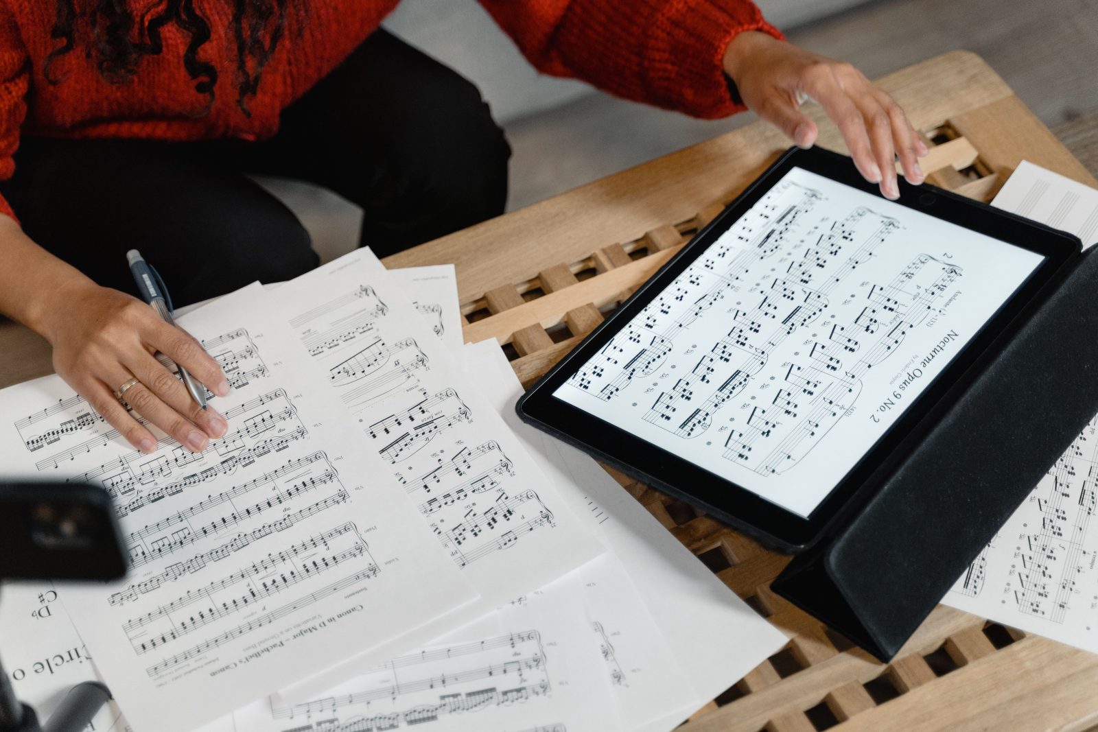 Musician working with sheet music and notes on a desk