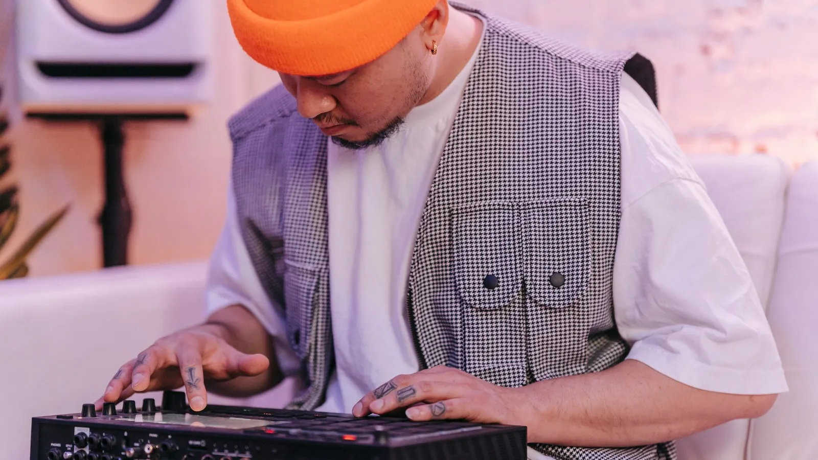 Music producer wearing headphones while working on beats for marketplace and owned-store sales