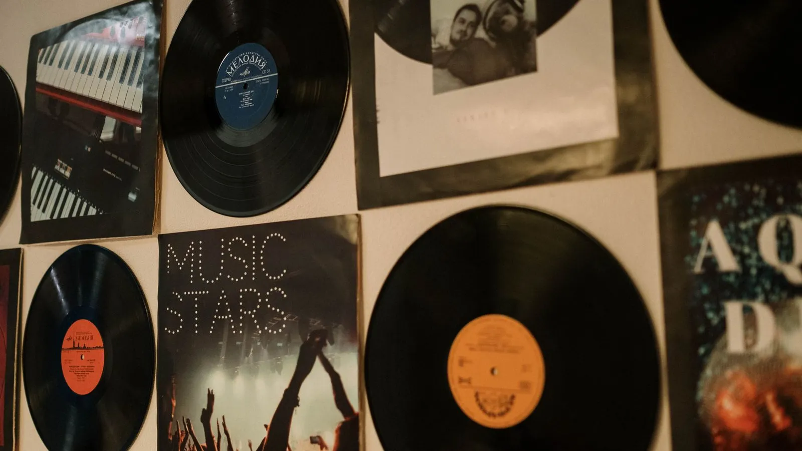 Vinyl records and album covers displayed on a wall